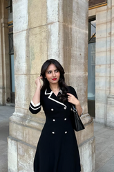 a lady wears a black Audry style mini dress